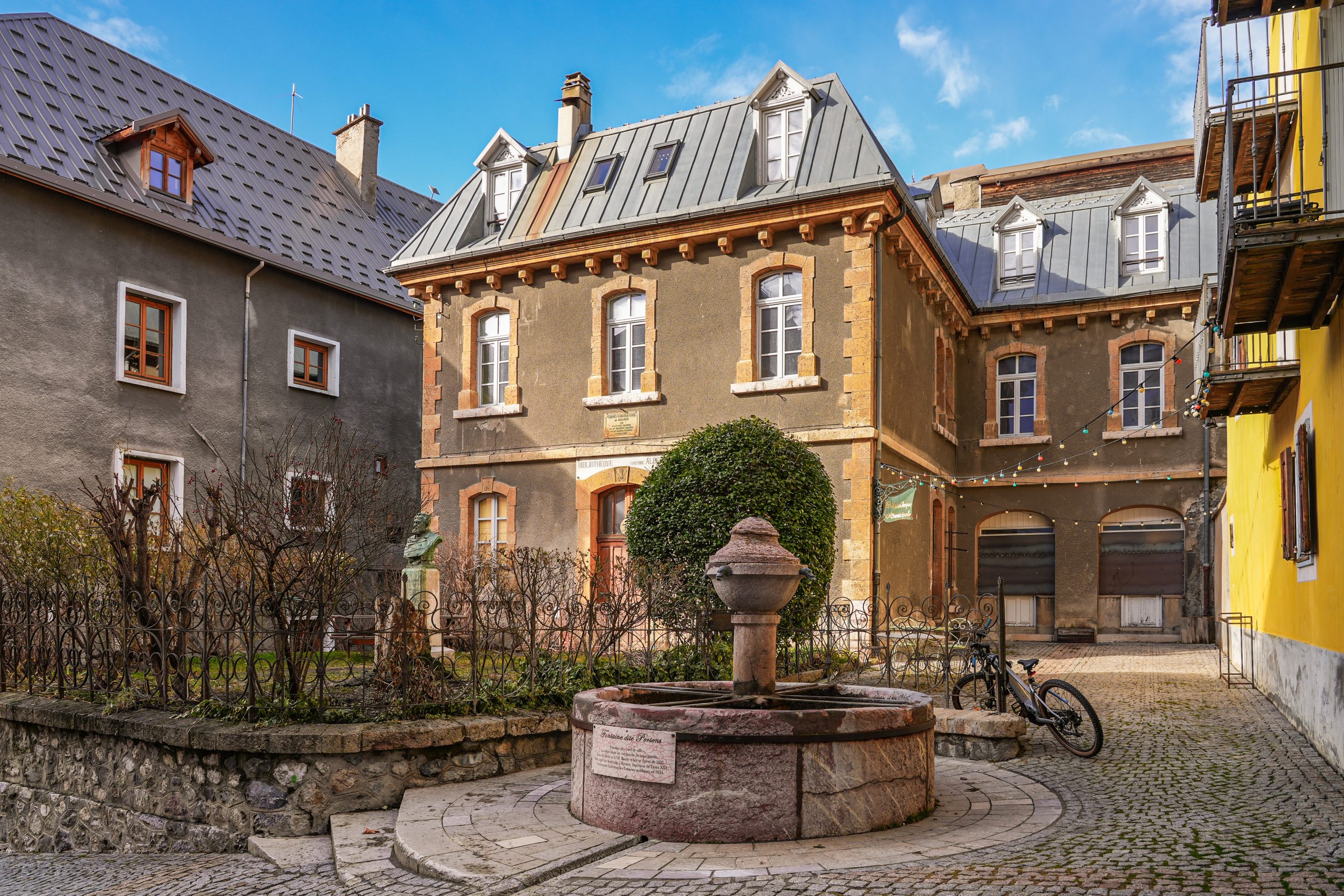 Maison Soyeuse AdobeStock 771035178 3 scaled Facade of the Public Library of Aristide Albert with the Fountain of Persens in Briançon, a fortified city built by Vauban in the French Alps